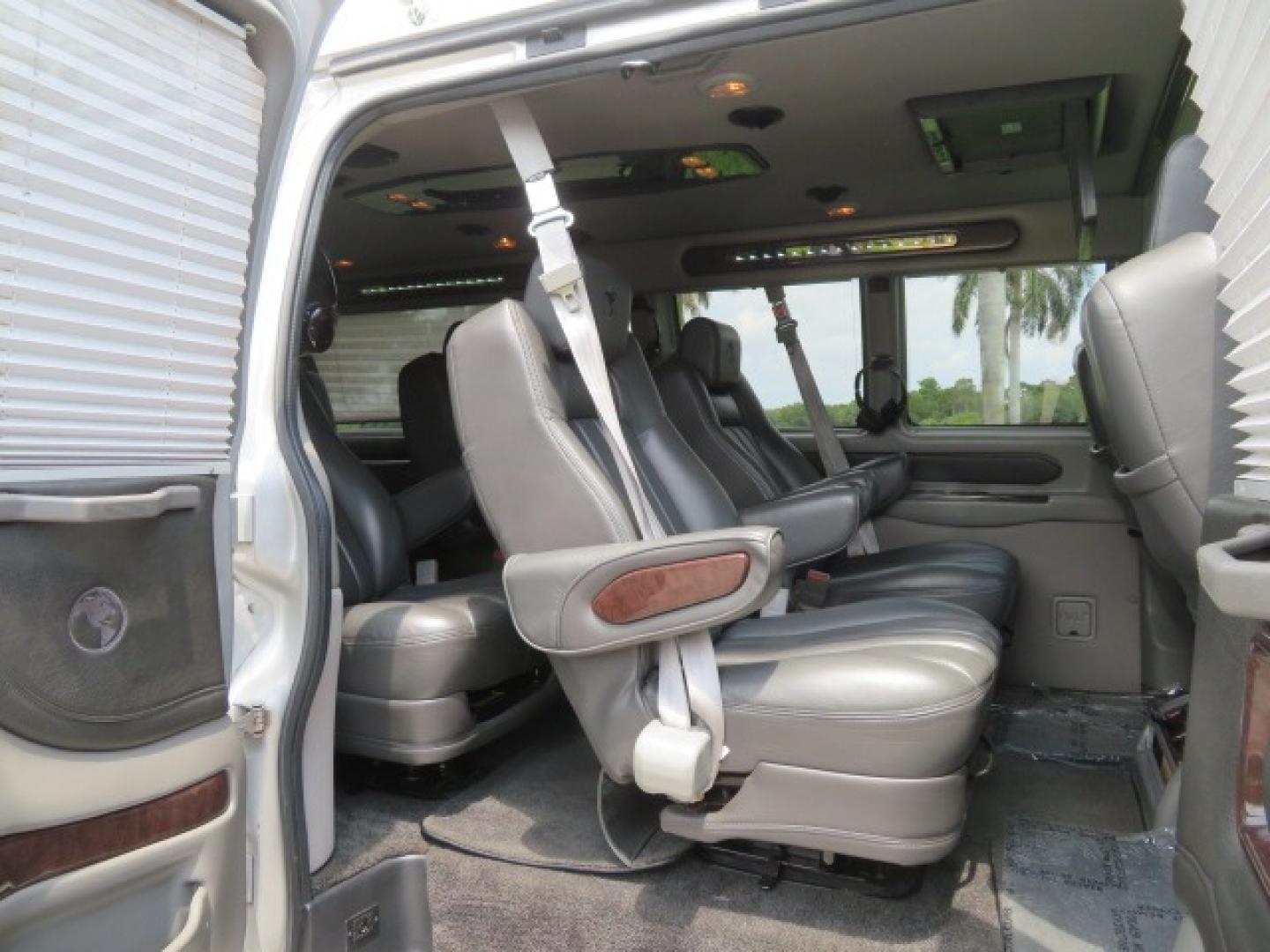 2014 Chevrolet Express (1GBWGLCG3E1) , located at 4301 Oak Circle #19, Boca Raton, FL, 33431, (954) 561-2499, 26.388861, -80.084038 - You are looking at a Rare 2014 Chevy Express 2500 Quigley 4x4 Four Wheel Drive Explorer Limited SE 9 Passenger Conversion Van with: 107K Original Miles, 6 Captain Chairs, Rear Power Folding Bench Seat Bed, Center Consoler Cooler, Front PPF (Paint Protection Film) Explorer Limited Conversion Througho - Photo#46